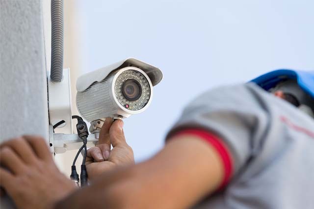 Profissional realizando manutenção em sistema de segurança